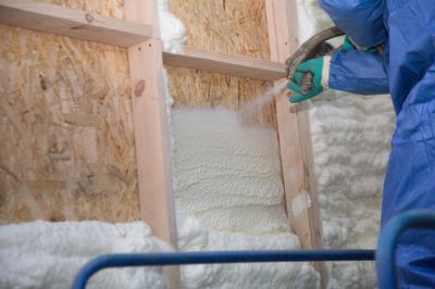 Insulation Being Secured in Wall Cavity